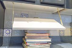 Attach the hinges to the bottom of the cabin Cookbook Shelves, Campervan Hacks, Pull Down Shelf, Cookbook Shelf, Diy Cookbook, Cabin Diy, Shelf Diy, Cookbook Holder, Reclaimed Doors