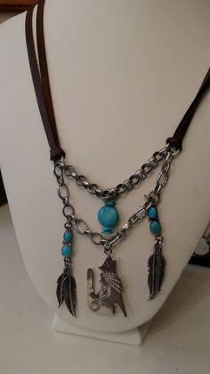 NEW LOWER PRICE Not unlike some of my other pieces, this piece has a southwest vibe. The vintage charms come right out of the desert with the howling coyote and feathers. The brown leather double cord with the accented turquoise beads really makes this piece stand out. Thanks for looking!! Bohemian Turquoise Jewelry With Vintage Charm, Turquoise Bohemian Jewelry With Vintage Charm, Turquoise Concho Bohemian Necklace, Turquoise Bohemian Concho Necklace, Vintage Concho Necklaces For Festivals, Bohemian Concho Dangle Jewelry, Vintage Concho Necklace For Festival, Bohemian Concho Jewelry For Western-themed Events, Vintage Handmade Necklace For Western-themed Events