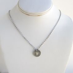 "A unique pendant necklace that I made with an original vintage Forth Worth 1942 transit token. The token is in-between a silver and gold tone (I see it as more silver tone but could be a very light gold tone). The token is 5/8\" in diameter and I used a silver tone chain and lobster claw clasp (you can choose from 18\" or 20\" length chain). It will come in a new gift box and the piece in the photos is the exact one you will receive. Please let me know if you need more than one. I also have oth Vintage Everyday Charm Necklaces With Round Pendant, Everyday Vintage Charm Necklace With Round Pendant, Everyday Vintage Round Pendant Charm Necklace, Vintage Silver Dog Tag Necklace, Vintage Hand Stamped Jewelry For Everyday, Vintage Hand Stamped Necklaces For Anniversary, Everyday Silver Necklace With Vintage Charm, Vintage Hand-stamped Round Pendant Jewelry, Hand Stamped Silver Brass Jewelry