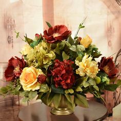 a vase filled with flowers sitting on top of a table