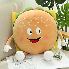 a stuffed hamburger sitting on top of a couch