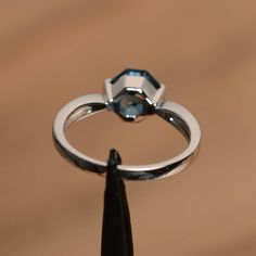 It is a London blue topaz ring. The main stone is 7 mm*7 mm octagon cut.weight about 1.86 carats The basic metal is sterling silver and plated with rhodium. To change the metal to a solid gold (white/rose) or platinum is also available, please ask for a quotation if you want. You can also go to my shop Home for more elegant rings: https://www.etsy.com/shop/godjewelry?ref=hdr_shop_menu London blue topaz is November birthstone More London blue topaz rings: https://www.etsy.com/shop/godjewelry?ref= Blue Topaz Emerald Cut Ring With Bezel Setting, Emerald Cut Blue Topaz Ring With Bezel Setting, Formal Octagon Topaz Ring In Sterling Silver, Silver Octagon Topaz Promise Ring, Blue Topaz Octagon Rings For Anniversary, Anniversary Blue Topaz Octagon Ring, Modern Octagon Topaz Gemstone Ring, Formal Blue Topaz Octagon Rings, Anniversary Octagon Blue Topaz Ring