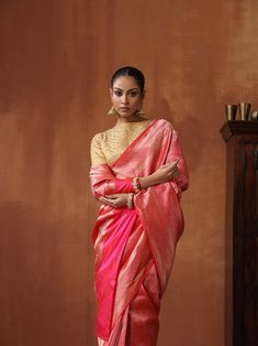 Experience the luxurious elegance of our Katan Silk Tanchoi Sarees, handcrafted with intricate Banarasi designs and premium Katan silk fabric. Available in a range of colors and styles, these sarees are the perfect choice for any special occasion The model is wearing blouse for styling purposes only. Luxury Gold Katan Silk Pre-draped Saree, Luxury Katan Silk Saree With Dori Work, Luxury Orange Katan Silk Saree, Luxury Resham Embroidered Katan Silk Saree, Luxury Katan Silk Salwar Kameez With Zari Weaving, Luxury Katan Silk Saree For Eid, Luxury Traditional Katan Silk Sets, Luxury Katan Silk Traditional Fabric, Luxury Bollywood Style Katan Silk Fabric