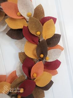 a close up of a wreath made out of felt flowers