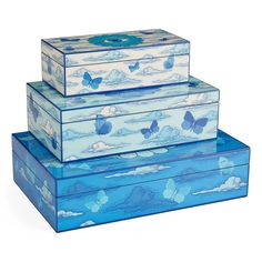 three blue boxes sitting on top of each other in the shape of clouds and butterflies