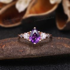 Amethyst Engagement Ring Unique Triangle Cut Moissanite Cluster Wedding Ring Art Deco Pear Shaped Purple Gemstone Rose Gold Bridal Ring RING DESCRIPTION ✦Engagement Ring ✴Center Stone - Amethyst Shape - Pear Cut Size - 6x8mm ✴Side Stones - Moissanite & Alexnadrite Shape - Triangle & Round Cut Weight - 0.26ct ✴Band Width - About 1.5mm ✴Ring Metal: Available in rose gold plated, yellow gold plated, 925 sterling silver, 10k or 14k solid rose, yellow or white gold. MAKING & SHIPPING ✦PAYMENT PLAN ♡ Elegant Amethyst Cluster Ring For Wedding, Amethyst Marquise Cut Wedding Rings, Fine Jewelry Amethyst Ring With Prong Setting For Wedding, Purple Solitaire Birthstone Ring For Wedding, Purple Cluster Ring With Center Stone For Wedding, Purple Three Stone Wedding Jewelry, Purple Pear-shaped Ring With Prong Setting, Heirloom Purple Ring For Wedding, Heirloom Purple Rings For Weddings