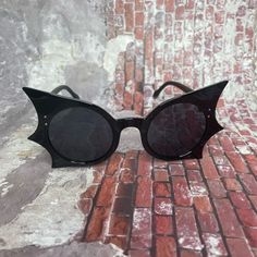 Oversized, Black-Framed Eyeglasses That Resemble The Shape Of Bat Wings. These Distinctive Glasses Feature Sharp Edges And Wide Lenses. The Frames Are In The Shape Of Wings Of A Bat, Giving Them A Unique And Eye-Catching Appearance. A Fashion Statement For Those Who Aren’t Afraid To Stand Out. Measurements Length 6” Width 6” Height 2” Bat Wing Sunglasses, Black Bat Jewelry, Hat With Bat Wings, Bat Wing Clothes, Bat Themed Clothes, Bat Themed Outfit, Bat Inspired Outfit, Alt Sunglasses, Bat Swimsuit