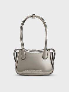 With a high-shine mirror-metallic finish, this Bosie top handle bag in pewter will set you apart wherever you go. Featuring two elongated handles and a distinctive shape, this cute and chic piece is an updated iteration of the classc lady-like bag style. Equipped with a zip closure that will keep your belongings secure, it exudes a modern femininity that can be dressed up or down to suit the occasion -- it will work well for both work days and the weekends. Korean Bag, Metallic Bag, Charles Keith, Bag Style, Handle Bag, Top Handle, Fashion Bags, Top Handle Bag, Handles