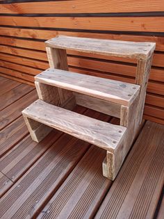 a wooden bench sitting on top of a wooden floor