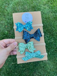 Your little sweetheart will look extra cute in these small baby bows. Each lightweight bow sits on a super soft nylon headband.  ---- {all the details} bow size varies by style  attached to nylon* choice of color or set  [other color options & sets available] Browse all our bows + clips here: https://www.etsy.com/shop/NEKcreative *please note the glitter center is wrapped around the nylon. As a result the glitter material will come in contact with the child's head ---- {a few more details} 1. Du Cute Adjustable Bow As Gift, Cute Blue Hair Accessories For Party, Cute Blue Party Hair Accessories, Cute Pink Bow Headband As Gift, Adjustable Blue Bow Hair Accessories, Blue Adjustable Bow Hair Accessories, Adjustable Green Hair Accessories For Gift, Cute Blue Headband For Gift, Cute Blue Adjustable Hair Accessories