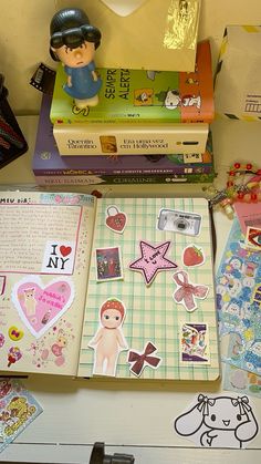 a bunch of books that are on top of a table with pictures and stickers