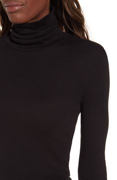 A timeless stretch-jersey turtleneck is updated with a trim fit. 26" length (size Medium). Semi-sheer. 50% pima cotton, 50% modal. Machine wash cold, tumble dry low. By Splendid; made in the USA. t.b.d. Elegant Fitted Mock Neck Top For Night Out, Fitted Fine Knit Mock Neck Top, Chic Turtleneck With Thumbholes, Elegant Mock Neck Top For Layering, Sleek Turtleneck With Funnel Neck, Fitted Mock Neck Top With Thumbholes, Chic Fitted Turtleneck With Thumbholes, Sleek Turtleneck For Fall, Chic Fall Turtleneck In Elastane