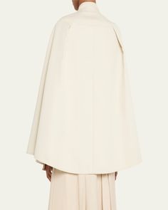 Max Mara "Valdez" cape in a flowing silhouette     Stand collar; concealed button front    Sleeveless    Front welt pockets    Oversized fit     Cotton    Made in Italy Oversized Elegant Cape For Spring, Oversized Cape With Cape Sleeves, Elegant Oversized Cape Poncho, Elegant Oversized Poncho Cape, Elegant Cape Poncho For Work, Oversized Chic Cape, Spring Workwear Cape, Bergdorf Goodman, Max Mara