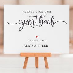 a sign that reads please sign our guest book thank you alice and tyler on it