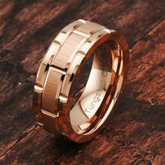 a gold ring with wooden inlays on it