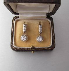 Antique 14K yellow and white gold drop earrings with diamonds, lever back. With an Austrian hallmark that was used between 1867 and 1937. Gemstone: Natural diamond, 2 pieces Weight: 1.3 carat Color: Crystal (I/J) Clarity: SI2 Measurements: Round, 5.8 x 3.16 mm each Cut: Old Cut Brilliant Finish: Corresponds to old cut requirements Fluorescence: none Not treated. Additional stones: Natural diamond, 6 pieces Measurements: 2.4 mm Weight: 0.3 carat Cut: Old Cut Brilliant Color: Crystal (I/J) Clarity Vintage White Diamond Earrings For Formal Occasions, Classic Hallmarked Yellow Gold Diamond Earrings, Antique Hallmarked Earrings For Anniversary, Classic Hallmarked Diamond Earrings, Classic Hallmarked Diamond Earrings For Formal Occasions, Classic Hallmarked Diamond Earrings For Formal Events, Vintage White Diamond Earrings, Antique 14k Gold Earrings For Anniversary, Hallmarked Art Deco Earrings For Anniversary