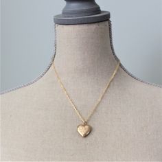 "This vintage locket is engraved with a floral design on the front; the reverse is plain. The gold filled heart, hallmarked 10k gf, opens revealing two compartments in which to place your favorite photos. The locket hangs from a new 14k gold filled cable chain accented with tiny white pearls at the clasp. Locket 24x21mm Necklace length 18\" (45cm) ✦All of our vintage lockets ship with complimentary insurance✦ ✤Our entire selection of lockets can be found here✤ http://www.etsy.com/shop/LexiandGem Brass Heart Charm Necklace For Wedding, Dainty Heart Pendant Locket Necklace For Wedding, Brass Heart Pendant Jewelry For Wedding, Brass Heart Pendant Wedding Jewelry, Valentine's Day Gold Necklace With Intricate Design, Heart Charm Pendant Locket For Wedding, Heart Charm Pendant Locket Necklace For Wedding, Wedding Heart Charm Pendant Locket Necklace, Personalized Heart Pendant Locket Necklace For Wedding