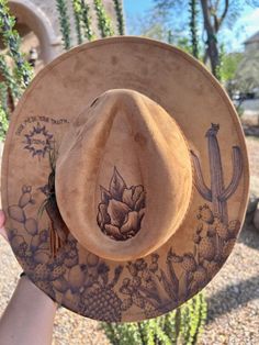 Unleash your individuality with our Custom Burned Hats, where your story becomes wearable art. Each hat is meticulously crafted and hand-burned to capture your unique journey, just like a tattoo but on a stylish accessory. Why You'll Love It: 100% Custom: Every design is tailored to your personal story, interests, and style. Artisan Craftsmanship: Hand-burned with precision and care, ensuring a high-quality, one-of-a-kind piece. Express Yourself: From birth flowers and landscapes to meaningful symbols and quotes, your hat will be a true reflection of you. Perfect For: Personal Style: Stand out with a hat that's as unique as you are. Special Gifts: Give a thoughtful and personalized gift for birthdays, anniversaries, or any special occasion. Memorable Keepsakes: Preserve memories and milest Hat Burn Designs, Cactus Burned Hat, Vintage Adjustable Hat For Festivals, Adjustable Vintage Hats For Festivals, Adjustable Vintage Hat For Festivals, Artsy Adjustable Hat With Curved Brim, Unique Adjustable Hat Bands For Rodeo, Adjustable Artsy Hats With Curved Brim, Unique Adjustable Brown Hat Bands