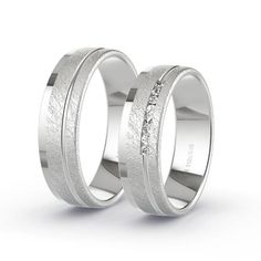 two white gold wedding bands with diamonds on each side, set in 18k white gold