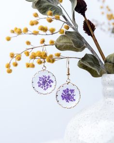 Handcrafted resin earrings featuring delicate fennel flowers encased in clear resin and finished with gold-plated findings.  Colors: purple, blue, pink, red, yellow, white. We will RESTOCK sold-out items soon!  Processing time: 1 business days Shipping time (time to arrive at your residency):  (1) standard shipping: 3-5 business days;  (2) expedited shipping: 1-3 business days;  (3) international shipping: 10-12 business days Care tips: - Take it off at the gym/pool/spa, even though it won't tarnish - Keep away from contact with perfumes, body oils, and other household chemicals Hypoallergenic Gold Flower Earrings With Resin, Gold Hypoallergenic Resin Flower Earrings, Hypoallergenic Gold Resin Flower Earrings, Gold Round Resin Flower Earrings, Gold Round Flower Earrings In Resin, Resin Flower Earrings With Pressed Flowers, Clear Resin Earrings With Pressed Flowers, Round Resin Earrings With Pressed Flowers, Gold Resin Flower Charm Earrings