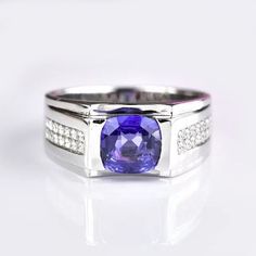 a ring with a purple stone surrounded by diamonds