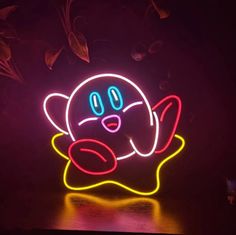 a neon sign with an image of a pacman on it's face in the dark