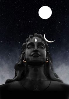 an image of a buddha statue with the moon above it