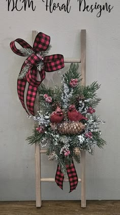 Wood ladder decorated with winter greens, berries, iced branches and cardinals on a pine cone. Finished with a buffalo check bow. #dcmfloraldesigns Christmas Ladder Decor, Christmas Ladders Ideas, Old Ladder Decor, Iced Branches, Frame Wreaths, Christmas Ladder, Mesh Christmas Tree, Boxwood Tree, Christmas Entry