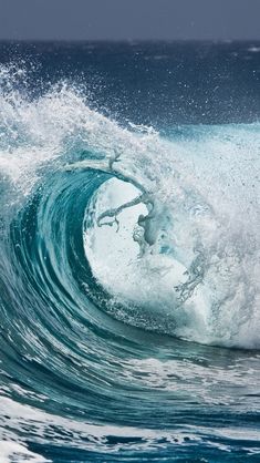 an ocean wave is breaking and the water looks like it's about to crash