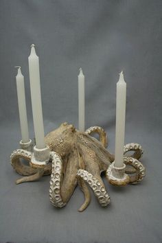 an octopus candle holder with five candles in it