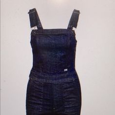 Slim Fitted Indigo Blue Jumpsuit In A Stretch Woven Denim In A Fun Updated Utility-Style. It Has A Side Zip, Adjustable Shoulder Straps, Oversized Front Pockets, Small Coin Pocket In The Side Seam, Patched On Back Pockets. Kir Stretch Denim Organic. Because It’s Fitting, A Large Fits Closer To A Medium And A Medium Closer To A Small. Casual Fitted Shortalls With Bib Front, Casual Fitted Bib Front Shortalls, Trendy Fitted Shortalls, Fitted Denim Shortalls With Pockets, Fitted Denim Blue Shortalls With Pockets, Casual Fitted Shortalls For Workwear, Fitted Casual Shortalls For Work, Trendy Dark Wash Fitted Overalls, Fitted Bib Front Casual Jeans