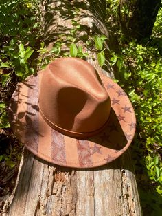 An American flag design on an adjustable wide brim fedora. Each hat is burned by hand. Shipping is included in the price. Rigid Wide Brim Western Hat, Americana Style Curved Brim Hat For Rodeo, Americana Curved Brim Hat For Rodeo, Custom Wide Brim Hat One Size, Adjustable Wide Brim Americana Hat, Americana Wide Brim Adjustable Hat, Americana Rodeo Hat With Curved Brim, Western Brown Wide Brim Hat, Jessica Caldwell