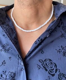 Experience the exotic beauty of the Elios White Shell Puka style Men Necklace! Made in the USA. This 14Kt gold-filled necklace is 16-17" long and sure to bring you seaside vibes wherever you are. A stylish addition to any look, its perfect for a beach day or a casual evening. Live seaside living with this unique statement piece! White Necklace For Everyday Summer Wear, White Everyday Necklaces For Summer, White Everyday Necklace For Summer, Elegant Beach Necklace With Tiny Beads, Minimalist Tiny Beads Necklace For Beach, Minimalist Beach Necklaces With Round Beads, White Long Necklace For Summer, Seaside Living, Casual Evening