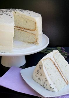 two pieces of cake on plates with one slice missing from the rest of the cake