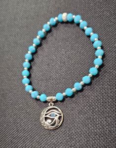 This is an EvilEye sterling silver charm. I used 6mm Opaque Turquoise faceted Blue Beads. I also used "24" 3mm Sterling Silver spacer beads, couple of 4mm sterling silver spacer beads, a 6mm Sterling Silver Stardust roundel spacer bead used as a closure. The  Evil Eye Charm is the Eye of Horus a Blue Eyed Egyptian. The Eye is supposed to give you health & protection. Beaded Sterling Silver Charm Bracelet Gift, Sterling Silver Beaded Charm Bracelet Gift, Spiritual Hypoallergenic Round Beads Jewelry, Sterling Silver Adjustable Charm Bracelet, Turquoise Beaded Bracelets With Silver Beads, Turquoise Sterling Silver Jewelry With Charms, Adjustable Sterling Silver Charm Bracelet With Round Beads, Turquoise Beaded Bracelets With Silver Beads For Gift, Spiritual Silver Charm Bracelet With Silver Beads