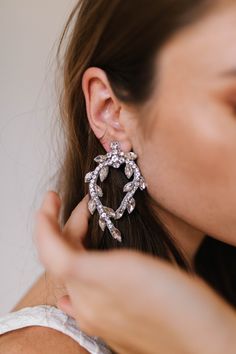 This Silver earring is intricately designed with crystal details. FINAL SALE Elegant Silver Jeweled Hoop Earrings, Elegant Jeweled Beaded Drop Earrings, Crystal Embellished Drop Earrings, Sparkly Flowers, Untamed Petals, Just Girl, School Dance Dresses, Small Crystals, Bridal Stores