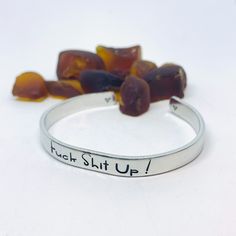 Hi, I’m Kathleen. I’m the owner & maker of Bang It Out Designs & Bawdy Bangles - I design and create hand stamped metal objects.*Description*The words “Fuck Shit Up!” in a fun font adorn this hand stamped aluminum cuff bracelet centered on the outside!My signature hand drawn heart designs can be found on the inside far ends of the bracelets for a nice touch!Materials: Food grade aluminum cuff bracelet - 6"x1/4"I personally hand stamp all of the lettering and designs in my NJ studio. Each Hand Drawn Heart, Hand Stamped Cuff Bracelet, Drawn Heart, Motivational Jewelry, Metal Objects, Hand Stamped Metal, Stamped Metal, Heart Hands Drawing, Heart Designs