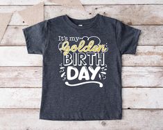 "It's My Golden Birthday Shirt,Golden Birthday Girl Tee,Birthday Party Gifts,Golden Birthday Boy Tshirt,Gold Toddler Birthday Tee,I'm Golden WE DON'T USE A REAL GLITTER. 🎁 Enjoy your shopping ! Need custom made shirts? Don't hesitate to message us! Thanks for your support! CustomShirtsZone_ Family ✨There are all sizes in the dropdown menu. These designs are for both kids and adults. Please make sure you purchased the correct size. ----- How To Order ----- 1-) Please, check and review all the photos. 2-) Choose your t-shirt size and color. *Different styles of shirts may have different shades of same color choice due to different manufacturer brands. *For this reason, we recommend you to match shirts from the same styles if you want precisely matching colors (ex. Unisex, V-necks, Toddler, Gold Letter Print T-shirt For Birthday, Gold T-shirt With Letter Print For Birthday, Gold Top With Graphic Print For Birthday, Gold Graphic Print Top For Birthday, Gold Top With Graphic Print, Golden Birthday Shirt, Birthday Party Gifts, Golden Birthday, Custom Made Shirts