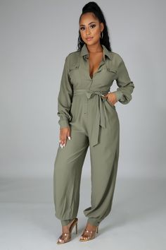 Long sleeve no stretch jumpsuit with collar neck and button closure. The jumpsuit has double pockets and a self tie. 100% polyester Model is wearing a size Small Button Up Jumpsuit, Stretch Jumpsuit, Green Jumpsuit, Collar Neck, Long Jumpsuits, Turndown Collar, Yellow Fashion, Fashion Pattern, Fashion Prints