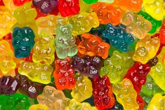 many different colored gummy bears are stacked on top of each other