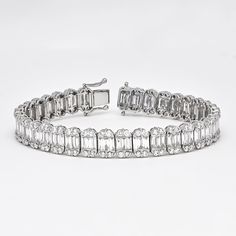 A chic row of channel set baguette diamonds flanked by classic round brilliant diamonds in a dome shaped setting, the bracelet embodies simple elegance at any occasion. Make sparkle a priority with this glamorous diamond tennis bracelet. Artfully set in 18k white gold, this exquisite bracelet features the soft shimmer of diamond baguette links gorgeously enhanced by round-shape diamond dome borders Diamond Bracelet Metal: 18kt White Gold Weight:19.43 Grams Gemstone: Natural Diamonds Shape: Bague Gold Tennis Bracelet, Diamond Earrings Studs Round, Diamond Baguette, Diamond Tennis Bracelet, Baguette Diamonds, Colorless Diamond, Wedding Jewelry Bracelets, Tennis Bracelet Diamond, Channel Set