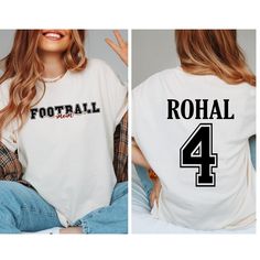 Custom Football Mom Shirt, Personalized Football Mom Shirt Gift, Name and Number Player  Football Shirt, Game Day Football Tee, Sports Mom, Football Dad Shirts 👉HOW TO ORDER👈 1️⃣ Please review all the information provided before placing an order 2️⃣ Select the shirt type and size using the drop down menu. 3️⃣ Select the color of the shirt using the following drop down menu. 4️⃣ Need more Items? Add the current item in the cart. And If you like to add more items to your order please press the back button and repeat steps 1-3 again. 5️⃣ Once all your desired items are in your cart you may complete your order by entering your payment method, desired shipping address and click submit. 👉SIZING👈 If you are unsure about the size you should order, please refer to the size chart in the pictures Football Season Team Spirit Tops With Lettering, Football Season Crew Neck Top With Lettering, Sports T-shirt With Lettering And Short Sleeves, White Sports T-shirt With Lettering, School Spirit Crew Neck Shirt For Sports Season, Football Season Graphic Print Crew Neck Shirt, White Tops With Team Spirit Lettering, Sporty Letter Print Shirt For Football Season, White Tops With Letter Print For Football Season