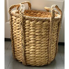 a large woven basket sitting on top of a wooden floor