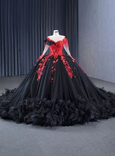 Whirlwind romance awaits in this captivating prom gown! Its bodice, a work of art, features a dramatic red floral lace that blooms passionately against the midnight-black background. The off-the-shoulder sheer sleeves whisper tales of elegance, flowing seamlessly into a heart-shaped neckline that frames the face with grace. The voluminous black tulle skirt, dusted with a constellation of sequins, swirls with every movement, making it impossible not to take center stage. Red appliques trail down the full skirt, echoing the whispers of love and luxury. Designed for those who command the spotlight, this dress is a perfect fusion of darkness and beauty, ideal for a night filled with endless dancing and unforgettable memories. Dark Red Dress Long Elegant Classy Ball Gowns, Quinceanera Red And Black, Black And Red Wedding Dress, Black And Red Wedding Ideas, Red And Black Quinceanera, Black And Red Wedding, Fitted Corset, Whirlwind Romance, Black Tulle Skirt