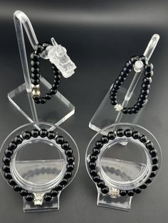 - This striking accessory features high-quality Black Onyx beads, exuding a rich, deep black hue that evokes a sense of power, sophistication, and confidence. - As a powerful grounding stone, it promotes emotional stability, mental clarity, and focus, while protecting negative energies and psychic attacks. - Black Onyx is also believed to enhance inner strength, resilience, and self-discipline, empowering you to face life's challenges with courage and grace. - Embrace the potent energy and capti Round Obsidian Jewelry With Black Beads, Elegant Black Jewelry With 8mm Beads, Round 8mm Beads Jewelry For Party, Round 8mm Bead Jewelry For Party, Party Jewelry With 8mm Round Beads, Party Jewelry With 8mm Beads, Black Crystal Bracelet With Round Beads For Party, Black Spiritual Bracelets For Party, Elegant Black Beaded Bracelets With 8mm Beads