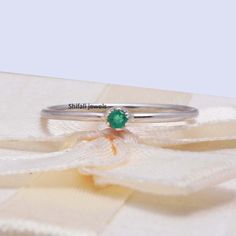 "RING DETAIL Metal : 925 sterling silver Center stone : Emerald Size of stone : 2.5mm Shape : Round About gems stone Emerald Emerald is a valuable gemstone that is likewise referred to by different names, for example, \"Panna\", \" Zamarrud\", \"Maragdam\", and \"Greenstone\" The tone changes from green to greenish-blue. It has a place with the mineral Beryl, the green is brought about by the presence of chromium, vanadium or iron (or any blend of those three components) and incorporates sea blu Green Sterling Silver Stackable Promise Rings, Green Emerald Stackable Rings In Minimalist Style, Stackable Minimalist Emerald Ring For Gift, Silver Minimalist Emerald Gemstone Ring, Dainty Silver Emerald Ring In Sterling Silver, Dainty Silver Sterling Silver Emerald Ring, Dainty Silver Emerald Promise Ring, Dainty Green Midi Promise Ring, Green Sterling Silver Stackable Emerald Ring