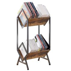 a wooden and metal book shelf with books on it's sides, against a white background