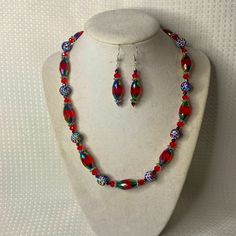 A Unique One Of A Kind Set Featuring Red Iridescent Marquis Shaped Glass, Round Glitter Rainbow Beads, And Crystals. Finished With A Pewter Clasp And Measures 18” Long. The Earrings Are In Sterling Silver And Measure 1.25” Long. Fun And Sparkly! Handmade Red Beaded Necklaces For Celebration, Red Beaded Jewelry For Party, Red Jewelry For Christmas Celebration, Red Christmas Jewelry With Colorful Beads, Red Faceted Beads Jewelry For Party, Red Faceted Beads Jewelry For Christmas, Multicolor Czech Glass Jewelry For Party, Red Round Beads Jewelry For Christmas, Multicolor Czech Glass Party Jewelry