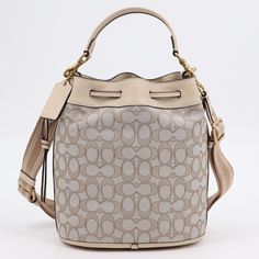 - Coach Signature Jacquard And Leather Field Bucket Bag - Brand New With Tags - Color: Stone/Ivory - 100% Authentic& Brand New - Made Of Signature Jacquard And Genuine Glove Tanned Leather - Gold Tone Hardware - Detachable Handle With 5 1/2" Drop - Adjustable, Detachable Strap With 16"-25 1/2" Drop - Drawstring Closure - Detachable Coach Embossed Leather Bag Charm - Fabric Lined Interior Features 1 Zip Pocket - Approximate Dimensions: 8 1/2" (L) X 10" (H) X 6" (D) - Includes Coach Dust Bag - Sto Pink Coach Purses, Embossed Bag, Black Leather Satchel, Leather Moccasins, Coach Shoulder Bag, Leather Hobo Bag, Black Shoulder Bag, Color Stone, Mini Shoulder Bag