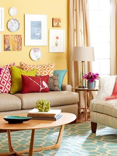 a living room filled with furniture and pictures on the wall